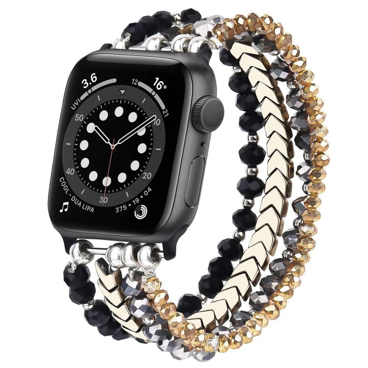 Beaded metal watch band with black, silver, and gold-tone crystal strands on a black watch.