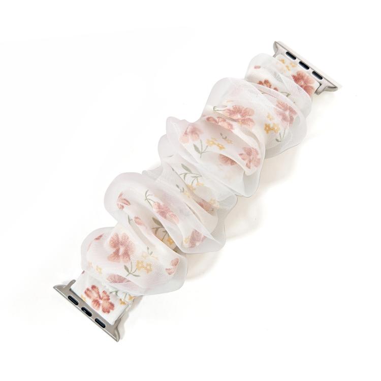 Ruffled organza Apple Watch band with a pale pink floral print, shown without a watch