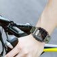 Smartwatch with a green camouflage silicone band worn on the wrist