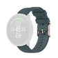 Dot-textured silicone watch strap in dark green with adjustable buckle and holes