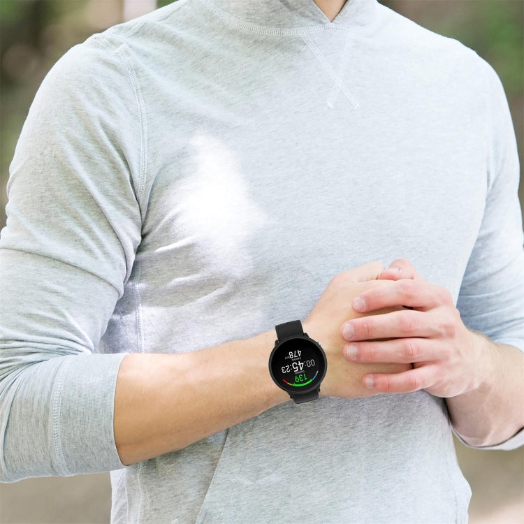 Dot-textured silicone watch strap in black on a wrist, shown with watch face