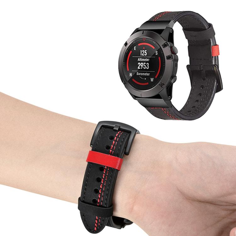 Black leather Garmin watch band with red stitching shown on a wrist and watch