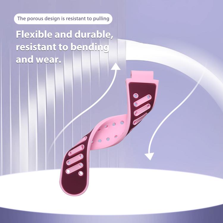 Flexible pink two-tone silicone watch band bent to show its perforated strap design