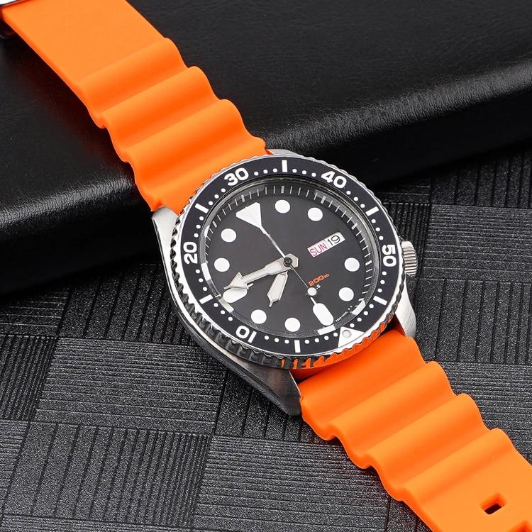 Orange silicone watch band fitted to a watch, with ridged ends