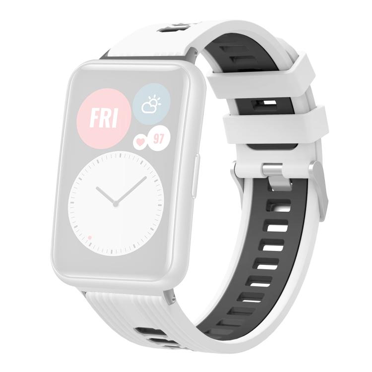 White and black silicone watch band with silver buckle, shown on a pale watch display