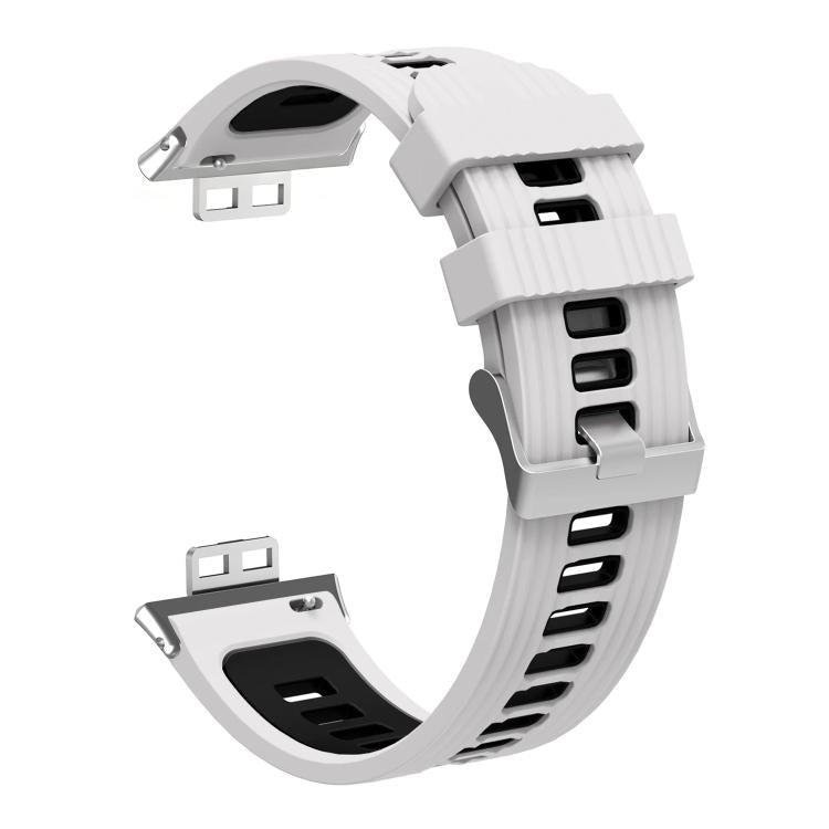 Reverse side of a white and black silicone watch band with silver buckle