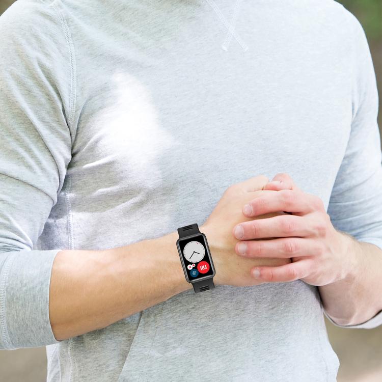 Black silicone watch band worn on a wrist
