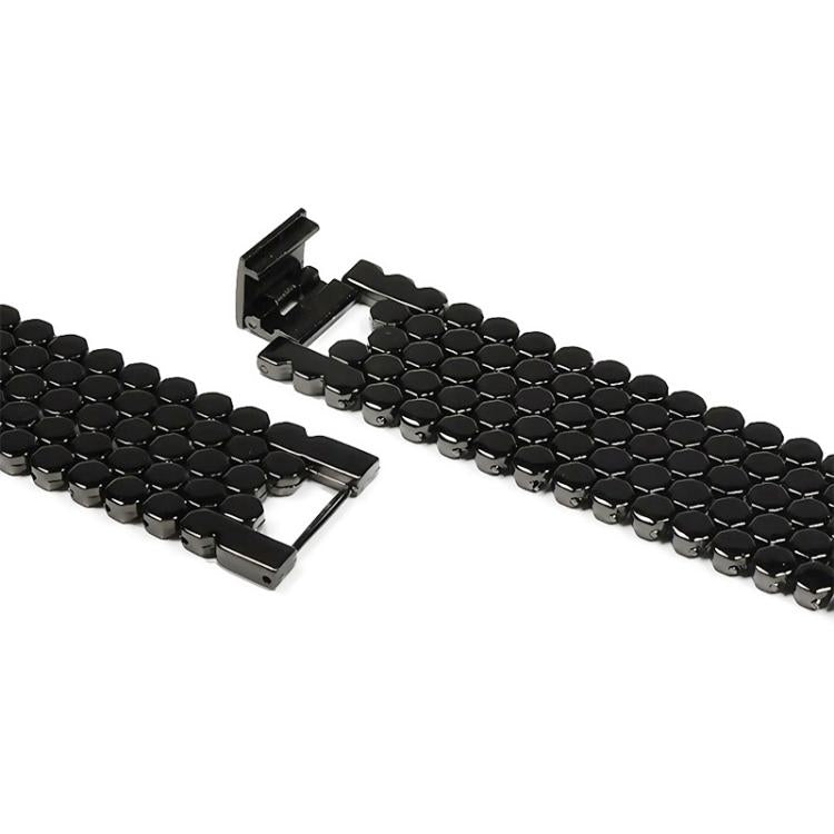 Black fish-scale metal watch band with folding clasp, shown close up