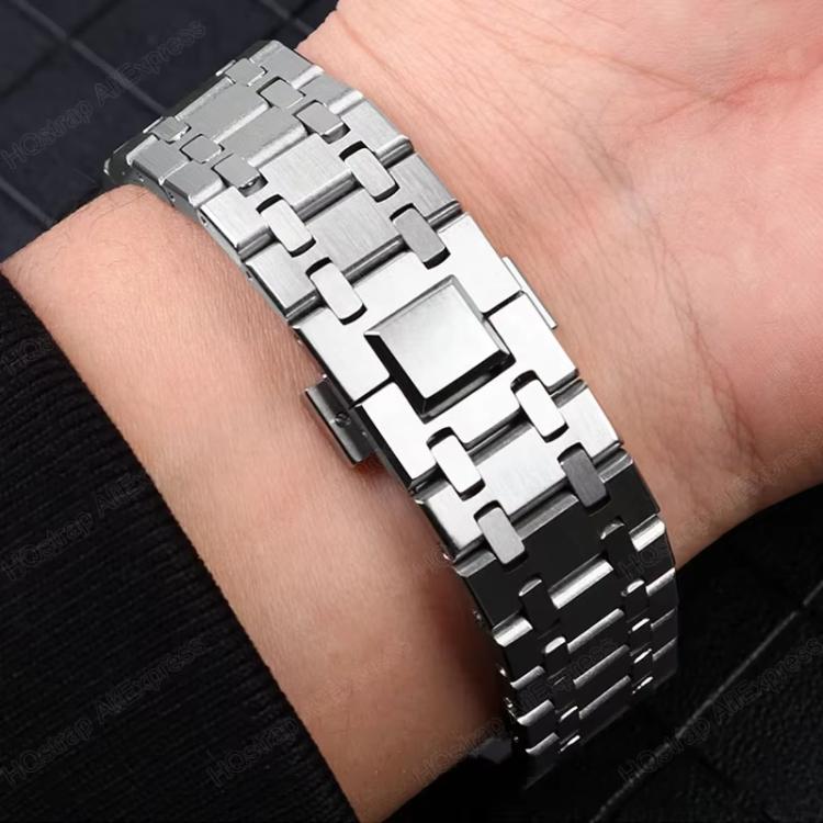 Silver titanium alloy watch band with interlocking links worn on a wrist.