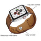 Tan leather watch band with stitched edges, buckle, and adjustment holes, shown on a watch.
