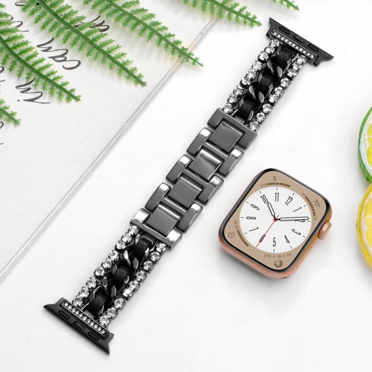 Black Apple Watch band with crystal-set edges and a braided chain center, shown beside a watch