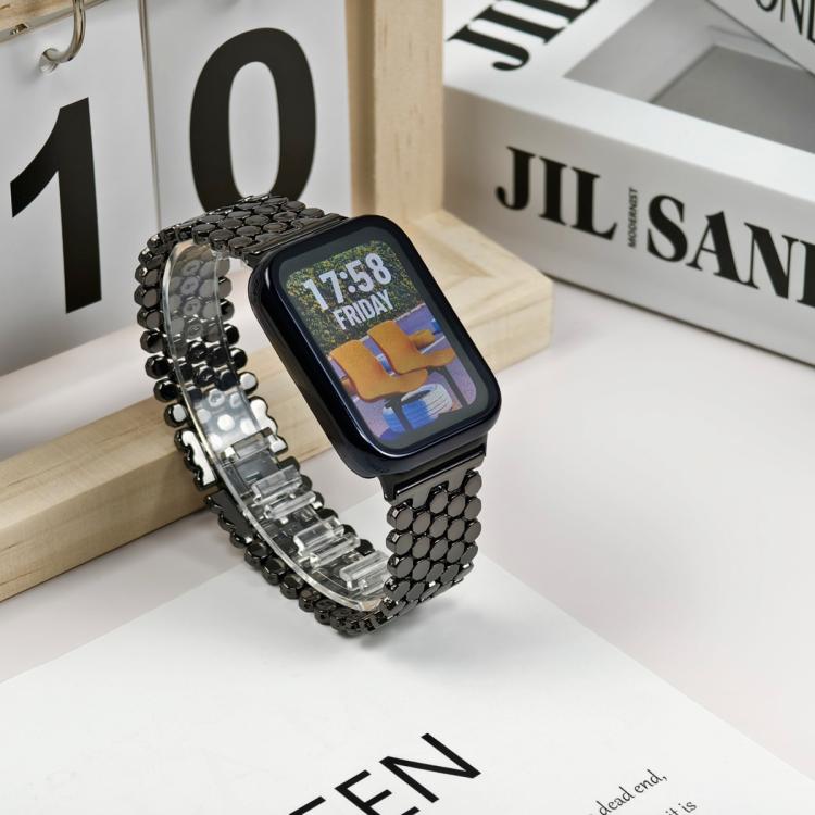 Black stainless steel fish-scale watch band fitted to a smartwatch