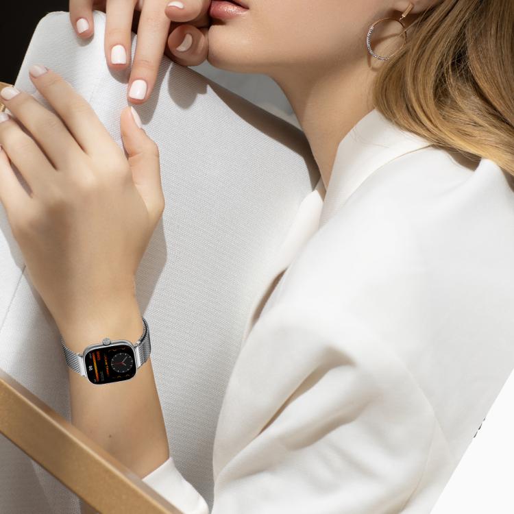 Silver mesh watch band worn with a smartwatch