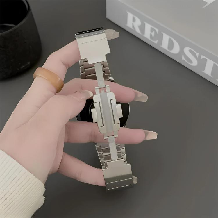 Silver stainless steel smartwatch band held open to show its folding clasp.