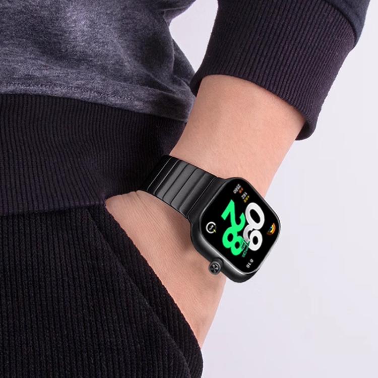 Black stainless steel smartwatch band worn on a wrist, shown with wide links.