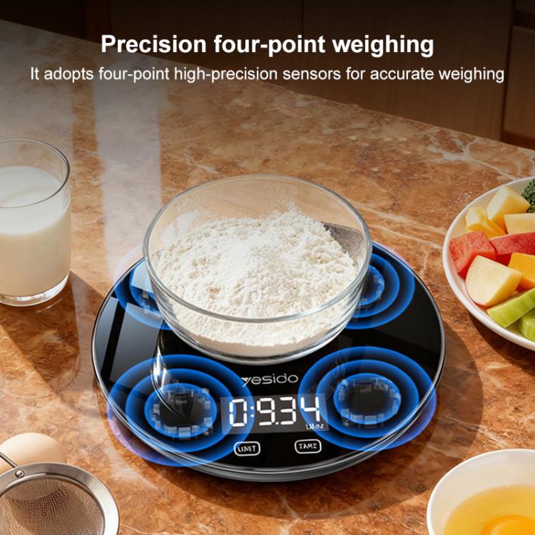 Black smart kitchen electronic scale with circular blue sensor rings and LCD display