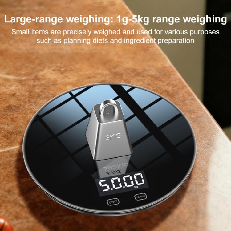 Round black kitchen electronic scale with a compact lifting top platform and LCD readout