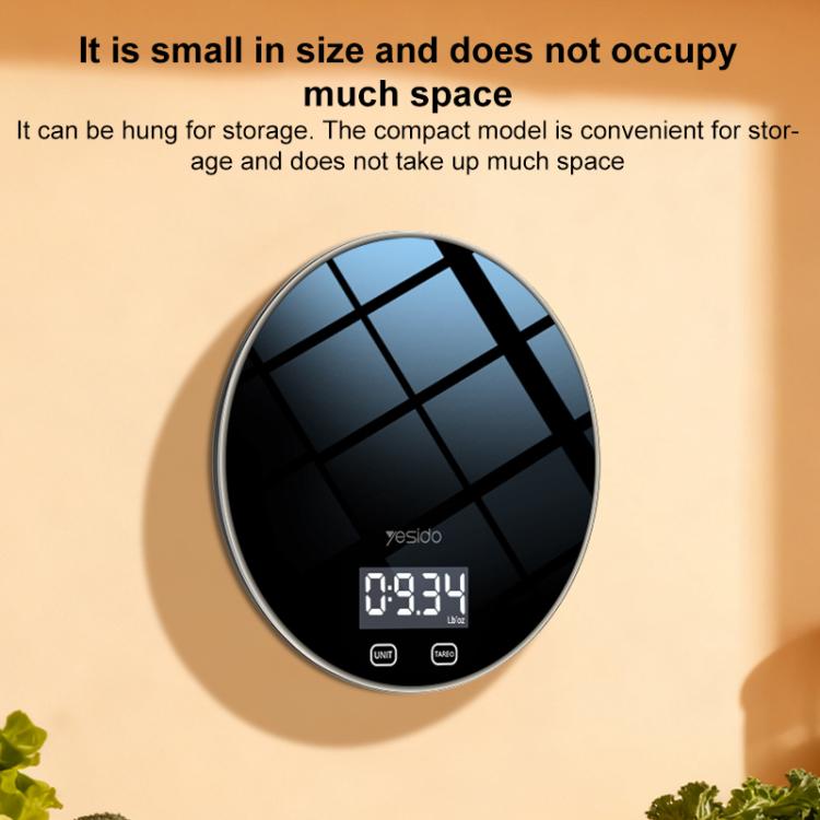 Compact round black kitchen electronic scale with LCD display and control buttons