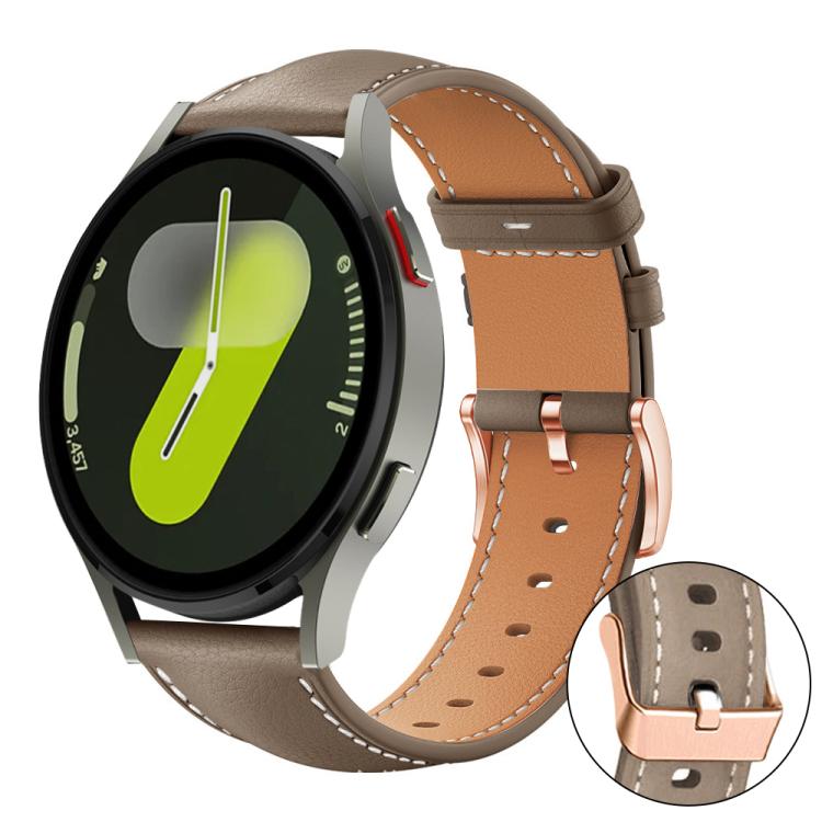 Brown watch band with tan lining, white stitching, and rose gold buckle