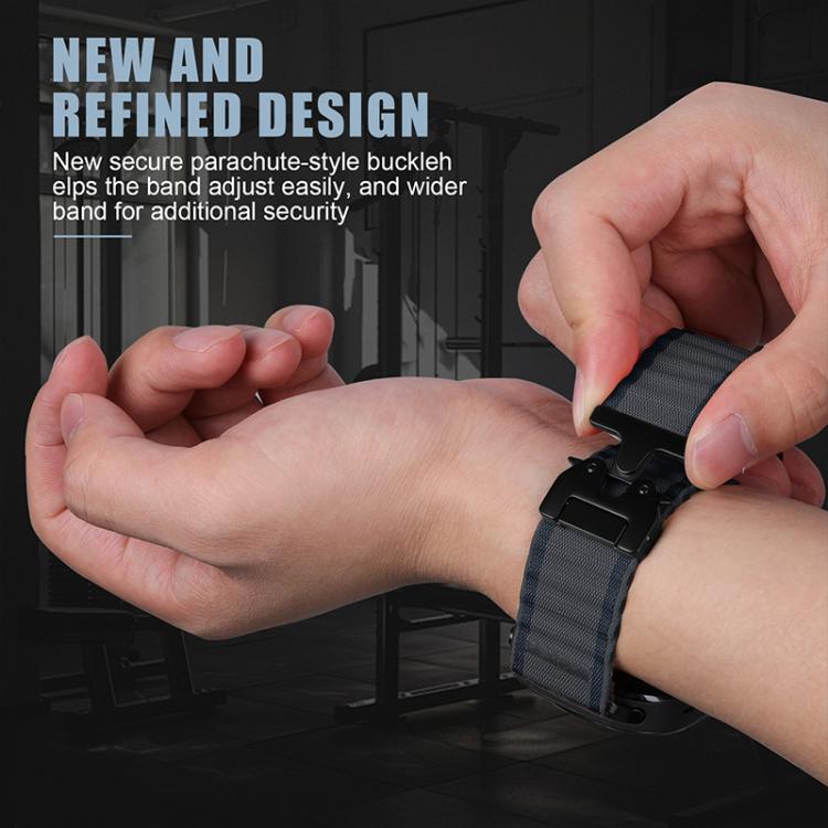 Dark nylon watch band being fastened with its secure parachute-style buckle.