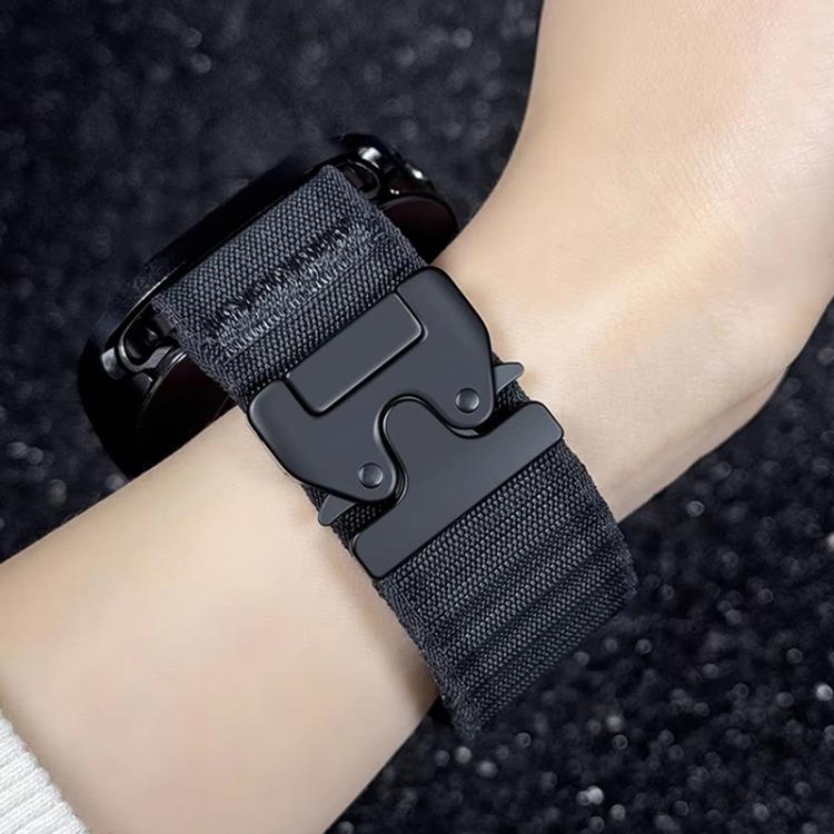 Dark nylon watch band shown close up with a black parachute-style buckle.