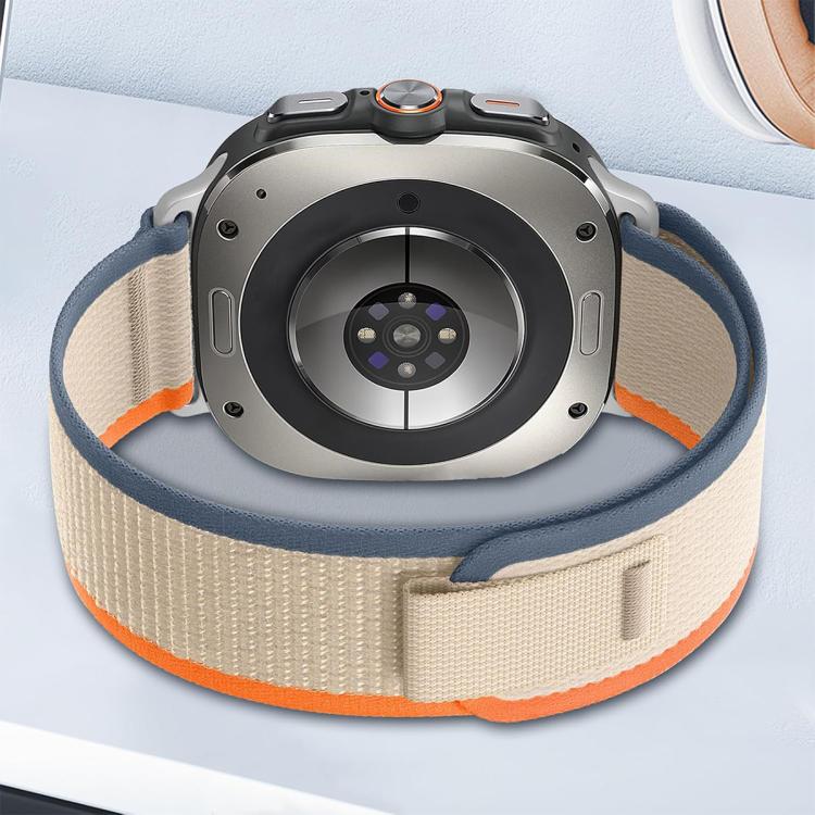 Beige nylon watch band with blue edging and orange trim, attached to a watch