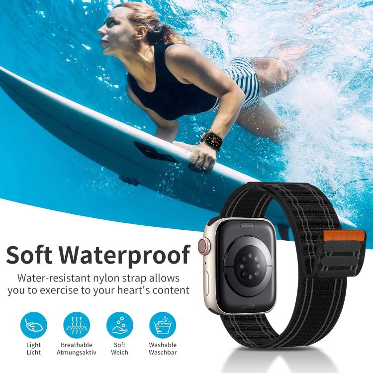 Black woven nylon watch band with orange tab shown on a smartwatch underwater