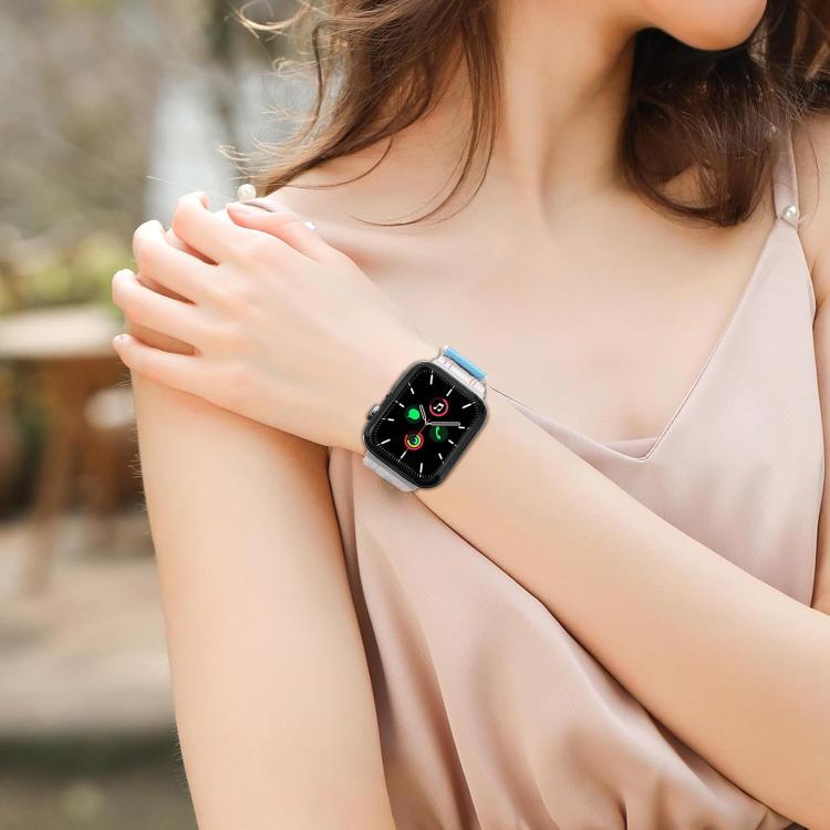 Apple Watch with a pale pink band worn on the wrist