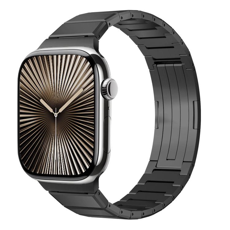 Dark metal Apple Watch band with linked bracelet and folding clasp, shown attached to watch.