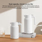 Two white insulated thermos flasks with handles on tabletop