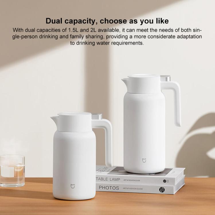 Two white insulated thermos flasks with handles on tabletop