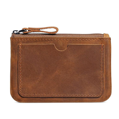 Brown leather coin purse wallet with zipper and wrist strap, front panel and stitching