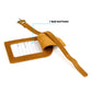 Tan leather card holder with pocket and buckled strap for luggage tag, stitched edges