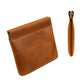 Brown leather coin purse with top zipper, orange stitching, and wrist strap