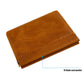 Brown leather coin purse with top flap, clasp, and orange stitching detail