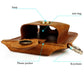 Brown leather waist bag open to reveal phone pocket, metal closure, and keychain