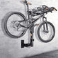 Black bicycle storage wall bracket securing a bicycle frame near the wall