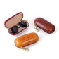 Open leather sunglasses storage box cases with sunglasses inside and gold zippers