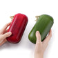 Hands holding red and green leather sunglasses storage boxes with gold zippers