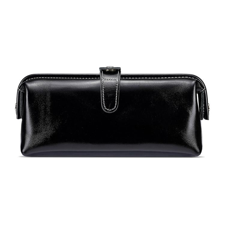 Black leather toiletry bag with top zipper, loop handle, and side tassel pulls