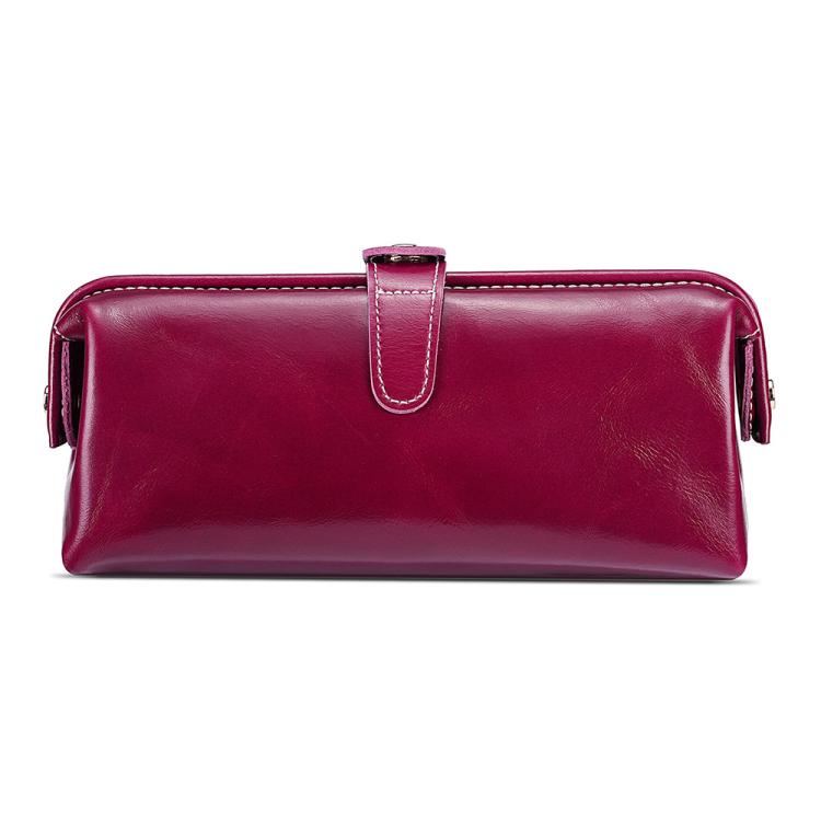 Wine red leather toiletry bag with top zipper, loop handle, and side tassel pulls