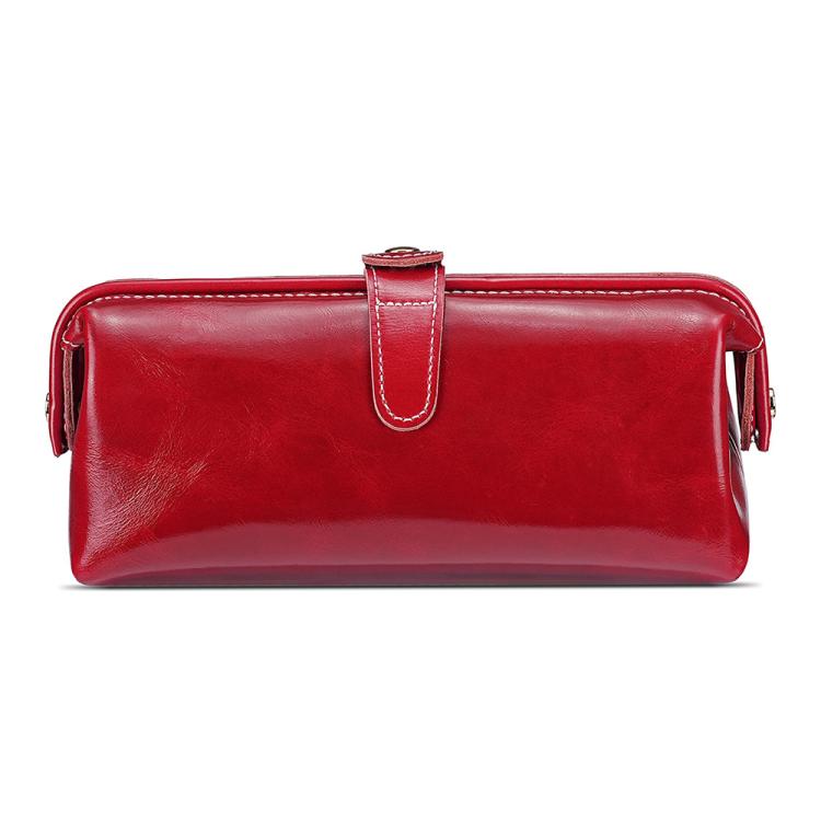 Red leather toiletry bag with top zipper, loop handle, and side tassel pulls