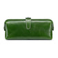 Green leather toiletry bag with top zipper, loop handle, and side tassel pulls