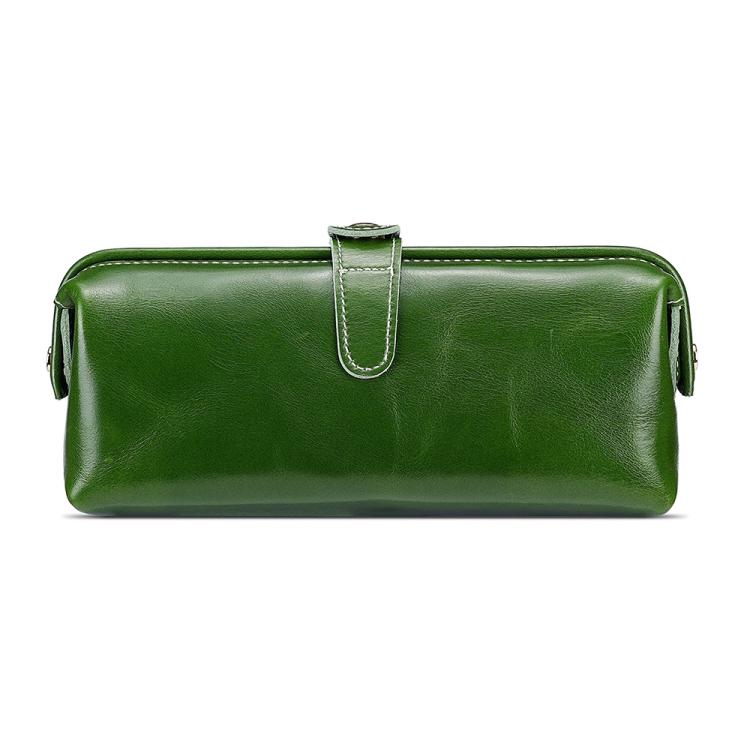 Green leather toiletry bag with top zipper, loop handle, and side tassel pulls