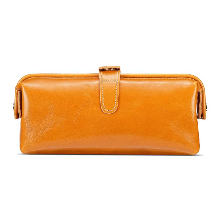 Orange leather toiletry bag with top zipper, loop handle, and side tassel pulls