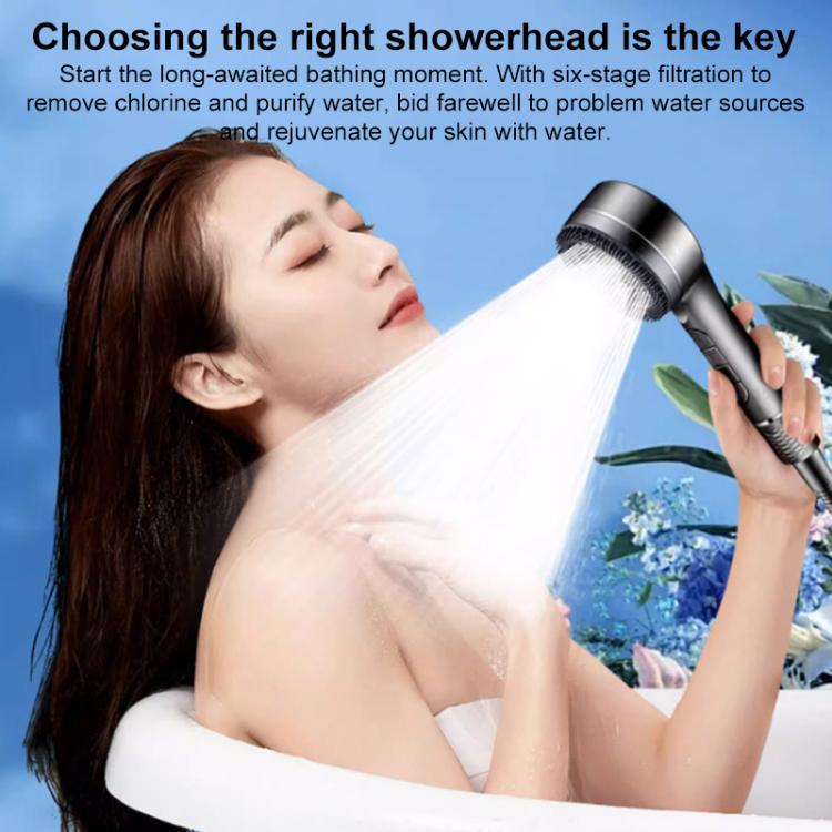 Handheld shower head spraying water over a person for full-body coverage
