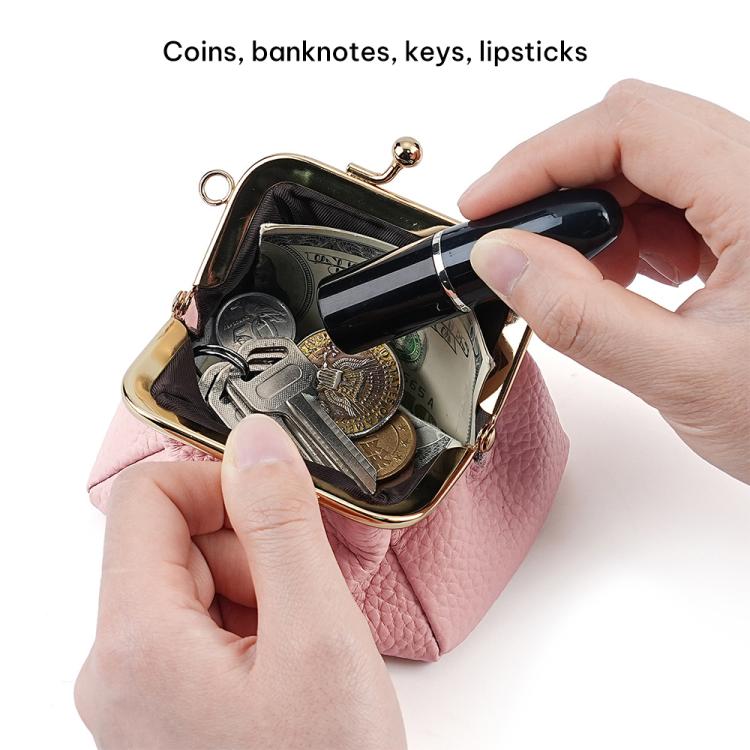 Small locking coin purse in pink pebble leather, clip frame open with coins and hand holding