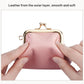 Pink pebble leather coin purse with kiss-lock frame, close-up of inner lining and clasp