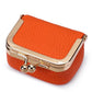 Orange quilted mini jewelry bag with gold-tone frame and front clasp