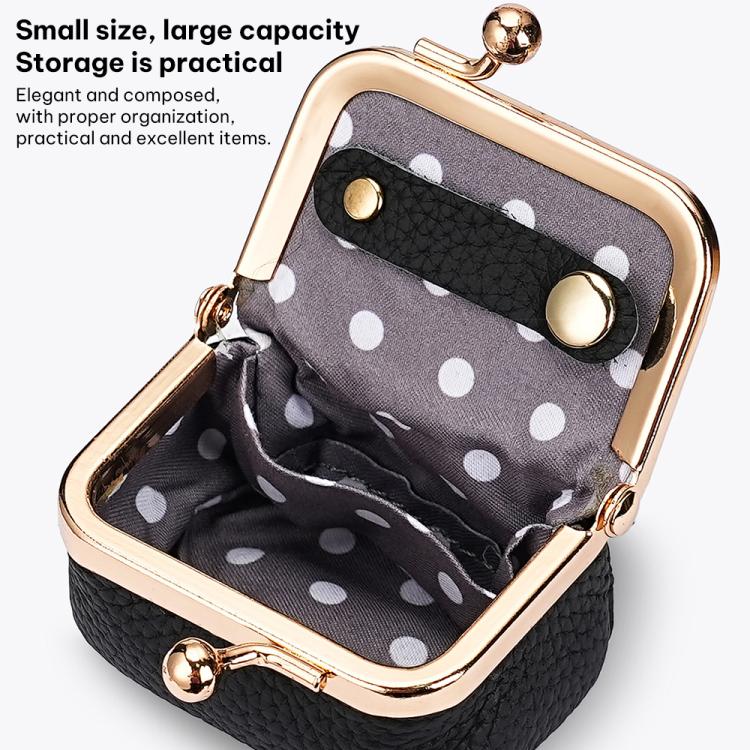 Black mini jewelry bag open to reveal polka-dot lining and clasp hardware